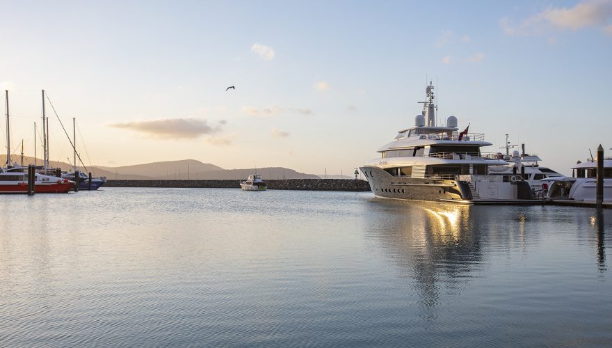 Superyacht vessel berthed at Coral Sea Marina Resort Superyacht arm at sunset, in the Whitsundays