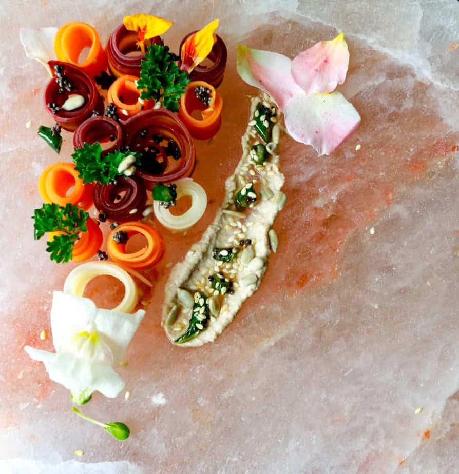 Rolled up carrot ribbons on a Himalayan salt plate.