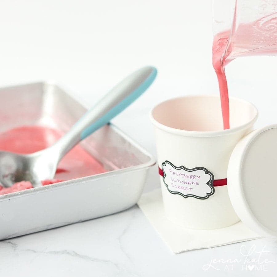 This delicious raspberry and lemon sorbet recipe is quick to make in a Ninja or Vitamix, does not require an ice cream maker and can easily be adapted for whatever fruit you want. Sounds like the perfect summer dessert to me! Pouring the sorbet mix into a container for the final freeze