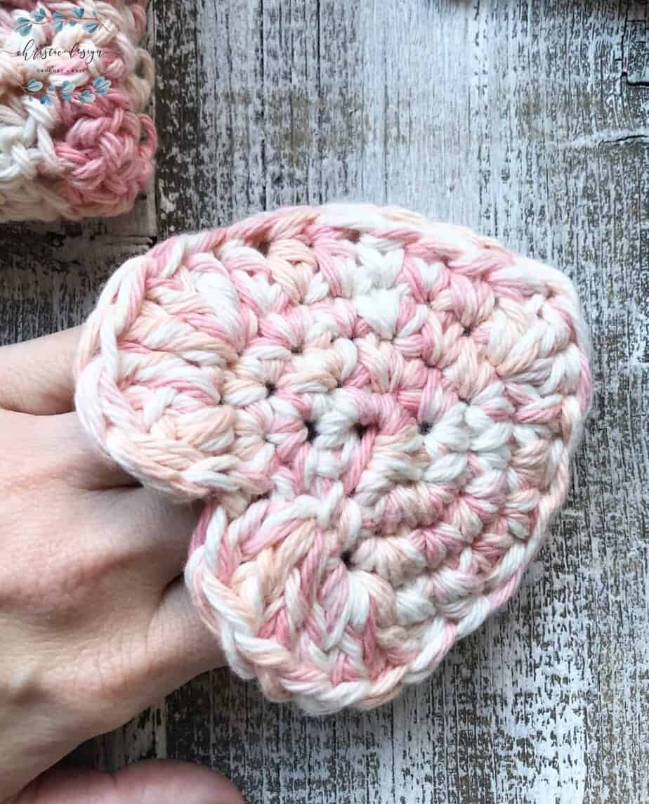 picture of hand in crochet heart scrubby pocket for face