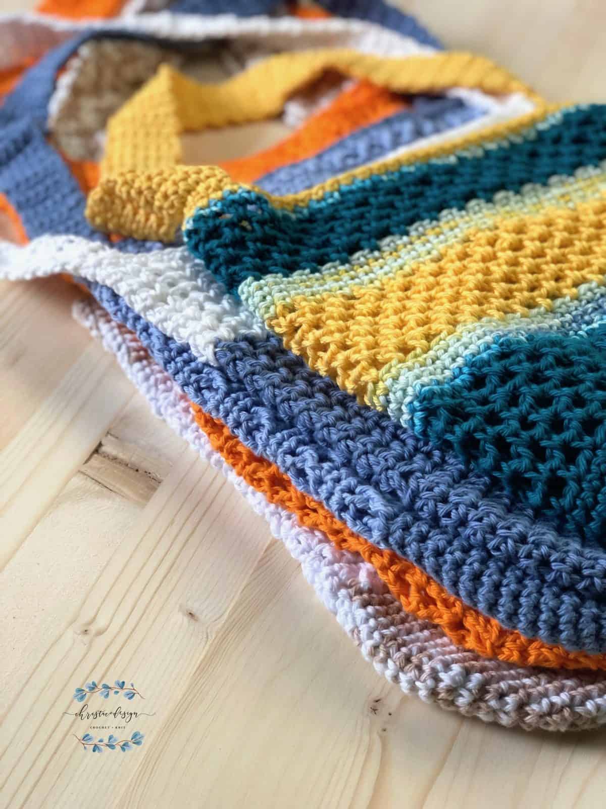 picture of stack of colorful crochet tote bags
