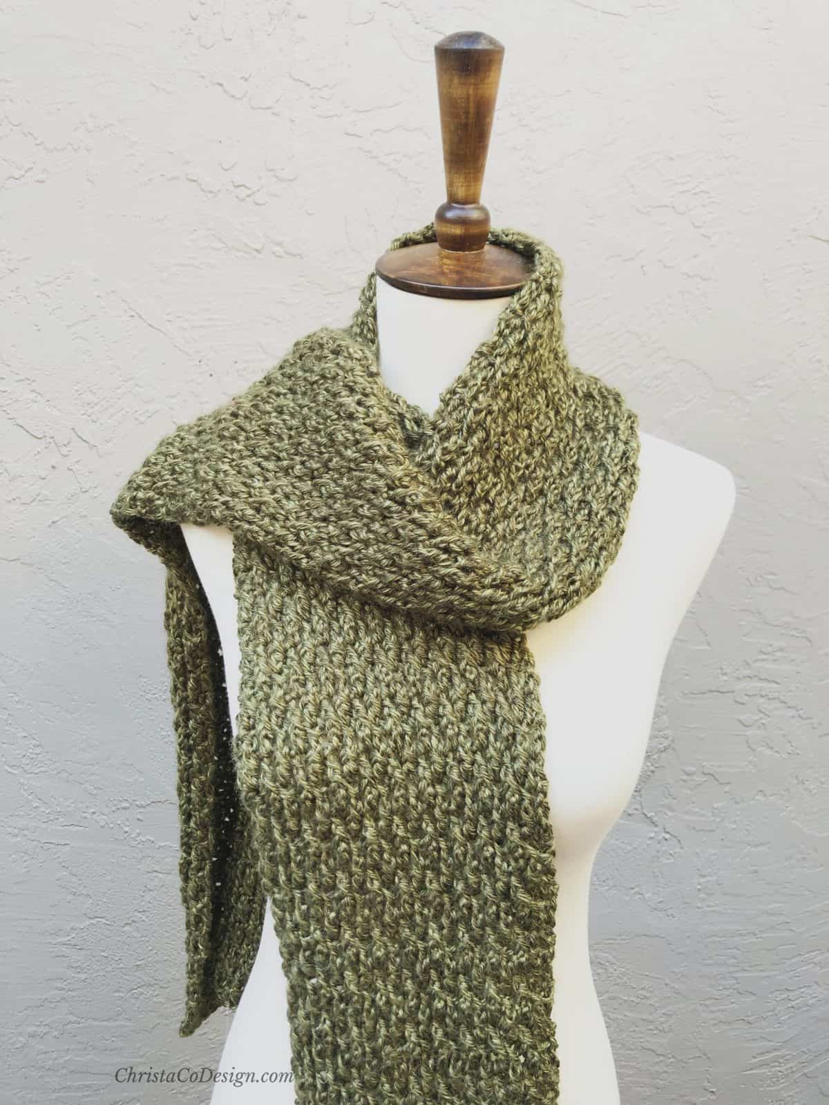 picture of textured crochet scarf on mannequin in green