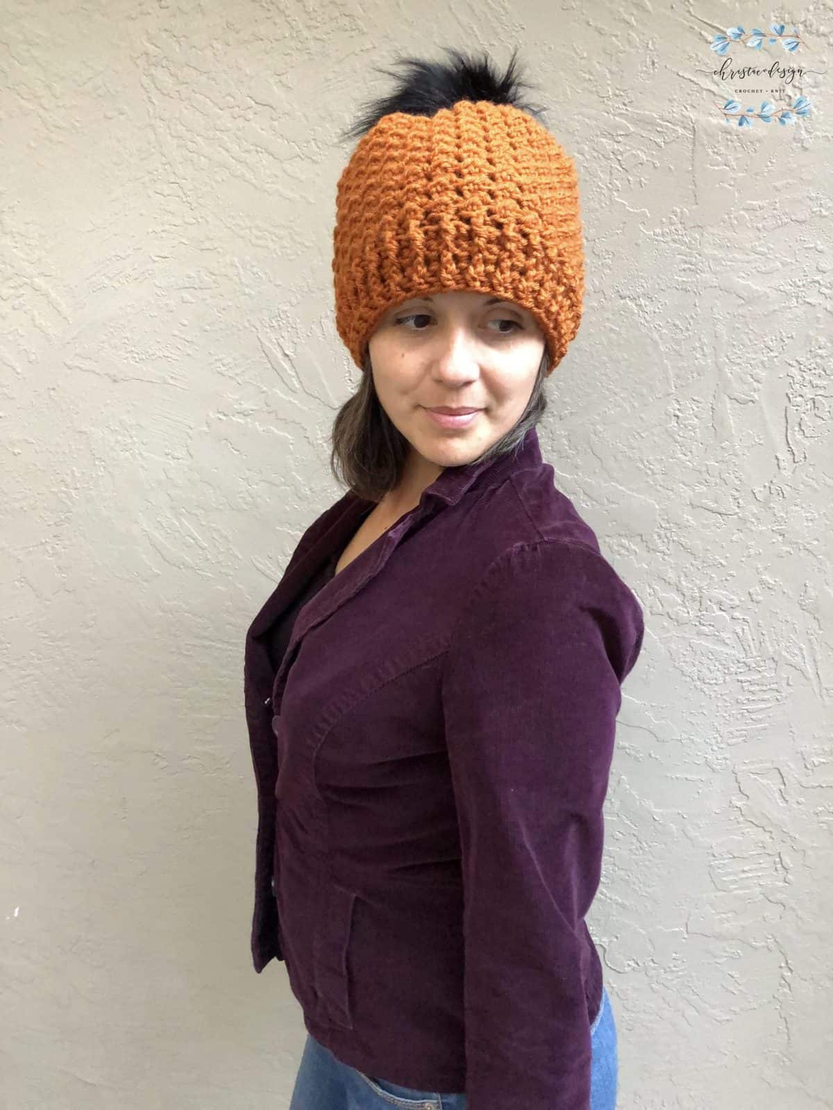 picture of woman in crochet textured hat rust colored