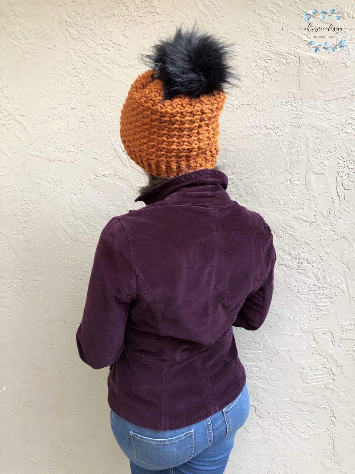 picture of woman in crochet textured hat rust colored