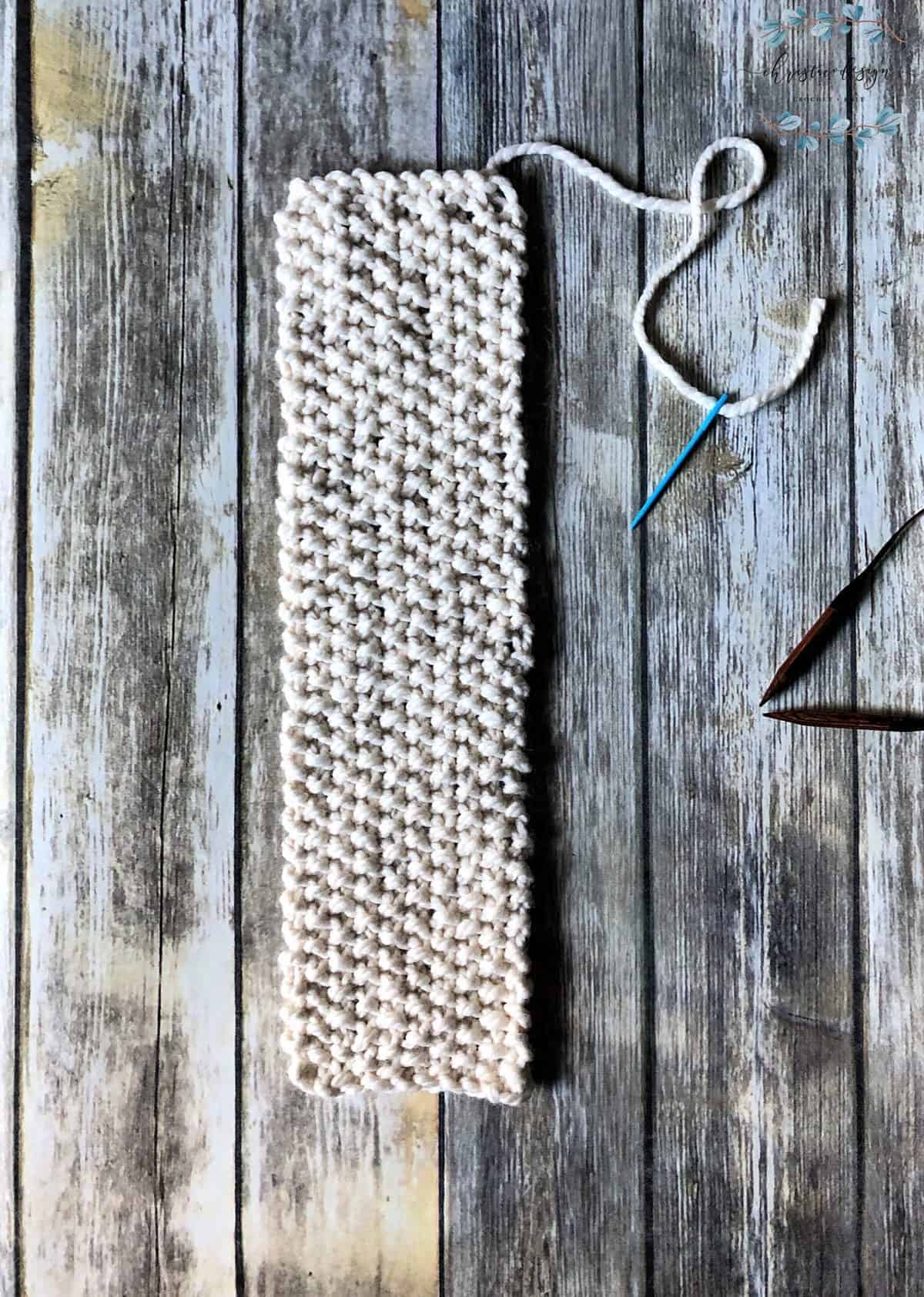 picture of knit ear warmer worked to length flat needle