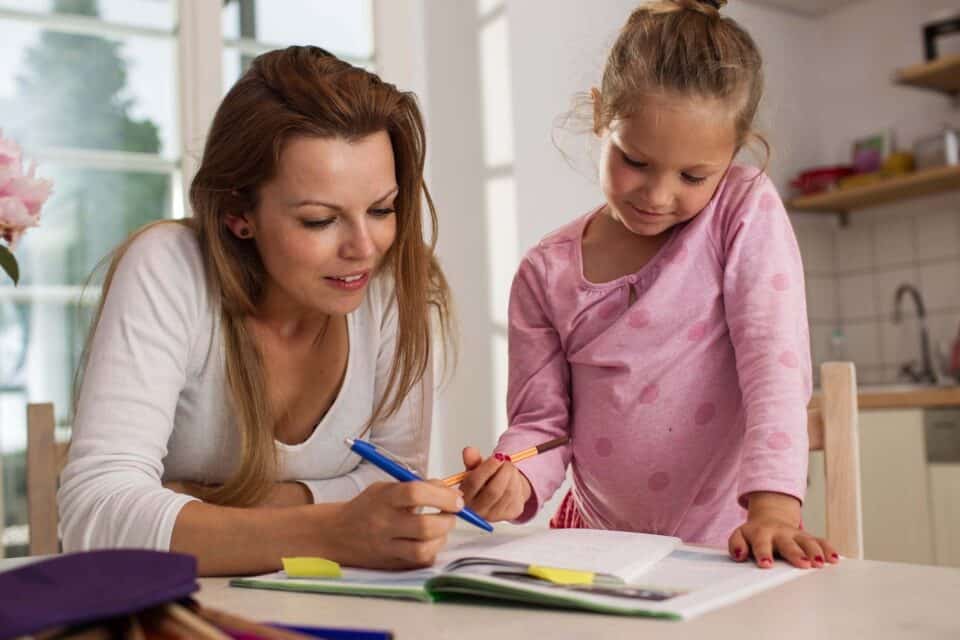 mum helping her daughter with homework