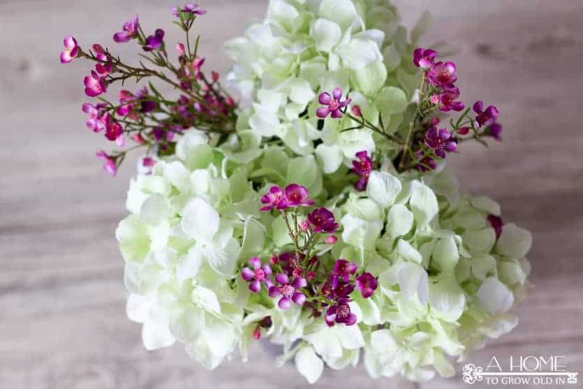 This spring floral door hanger is so easy to do and requires no floral arranging skills! A flower arrangement is a fun alternative to a wreath! Plus, I love the galvanized bucket!