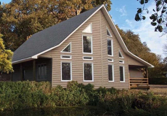 Montebello Vinyl Log siding House by Pond Montebello Vinyl Log Siding KayCan House by Pond