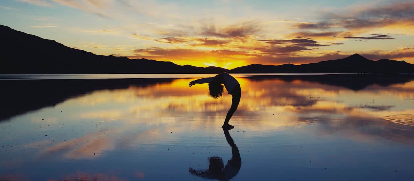 get your life back - girl stretching on beach after opiate detox