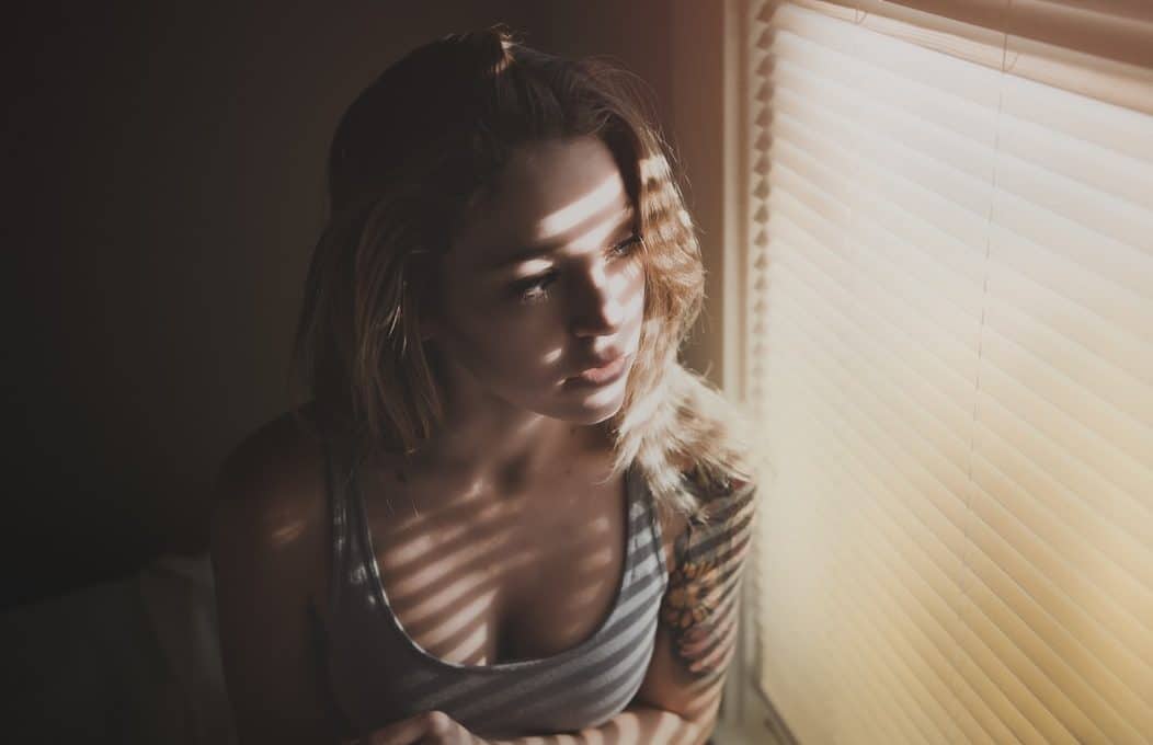 girl with ocd sitting near the window