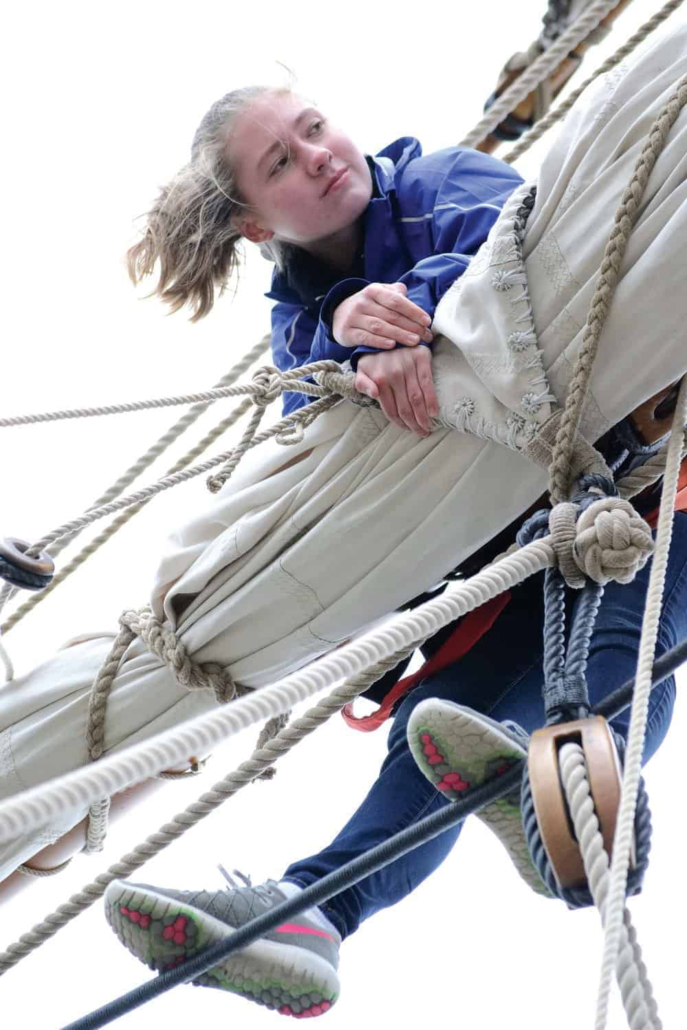Anna Hower tends to the sails aloft.- Photos by K aren Soule