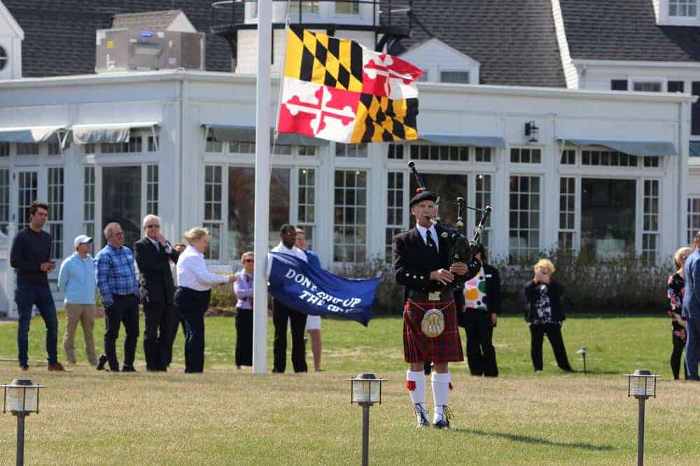 A bagpiper heralds the return of the fleet.