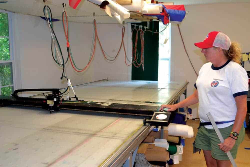 Stephanie Sweeney operates a cutting machine. Photo by Karen Soule.