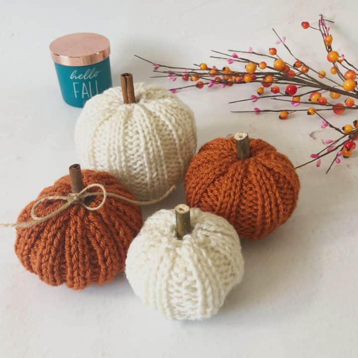 picture of fours small knit pumpkins in rust and cream