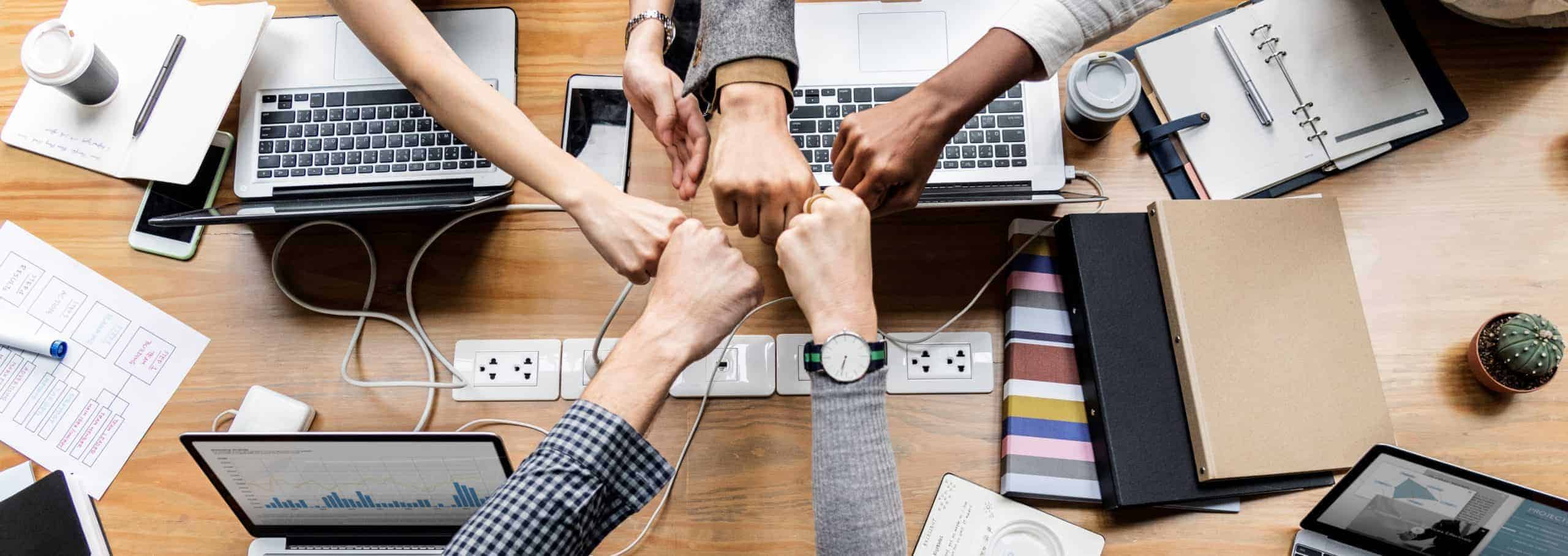 Colleagues giving a fist bump Collaboration is key to business planning