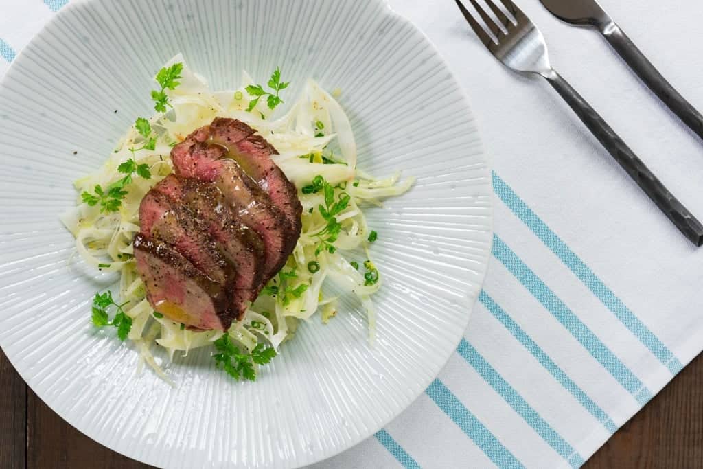 Shaved Fennel Salad with Steak With savory tender slices of warm steak atop a bed of crisp shaved fennel and a fragrant yuzu dressing, ths salad makes for a delicious summer meal.