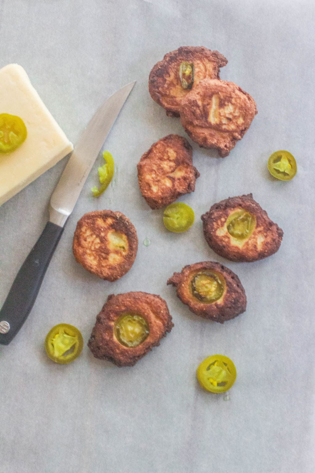 Jalapeño Cheddar Cornbread Fritters. Pickled jalapeño peppers and white cheddar added to cornbread batter and dropped by tablespoonfuls into hot grease. Fry until brown and crispy. #cornbread. #syrupandbiscuits #cheddarcheese
