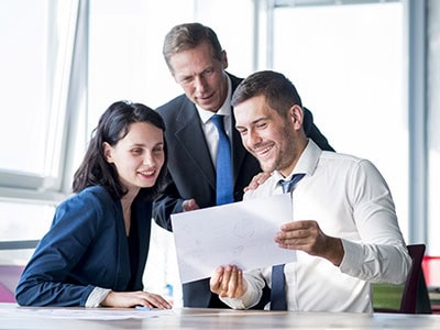 Three Business People Smiling at Lower Phone Bill