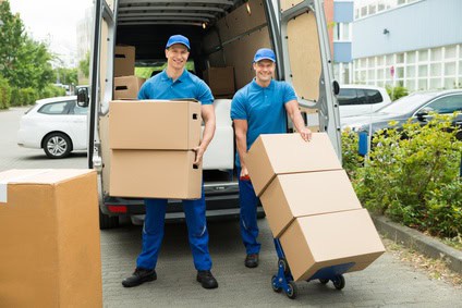 Two Workers Loading Cardboard Boxes In Truck