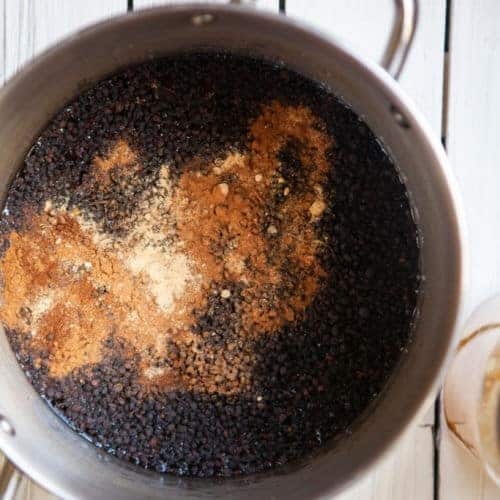 ingredients for fresh elderberry syrup in a pot