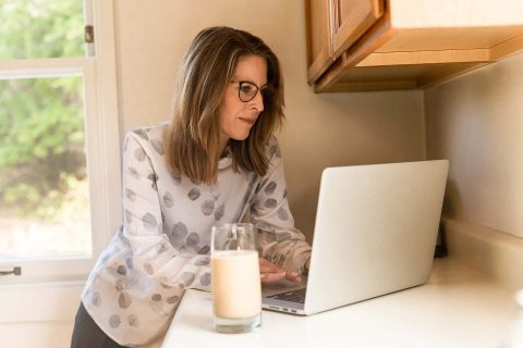 insurance claimant woman looking at laptop