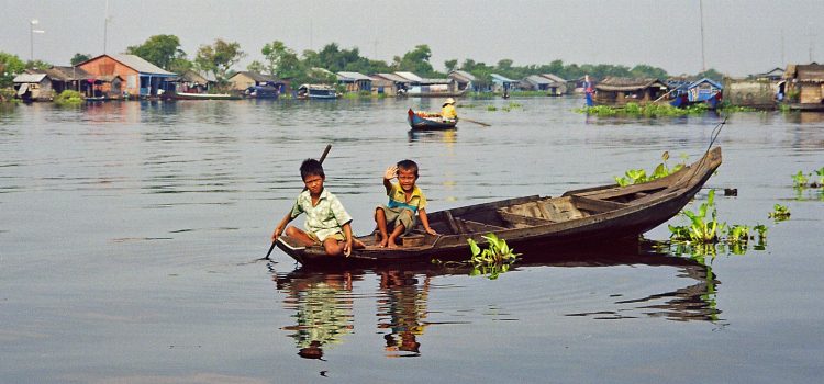 children waving at Tonle Sap lake during river trip to Battambang Scenic river trip to Battambang