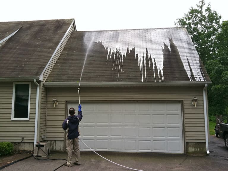 SpringBrook Employee Treating Roof during Roof Cleaning Process