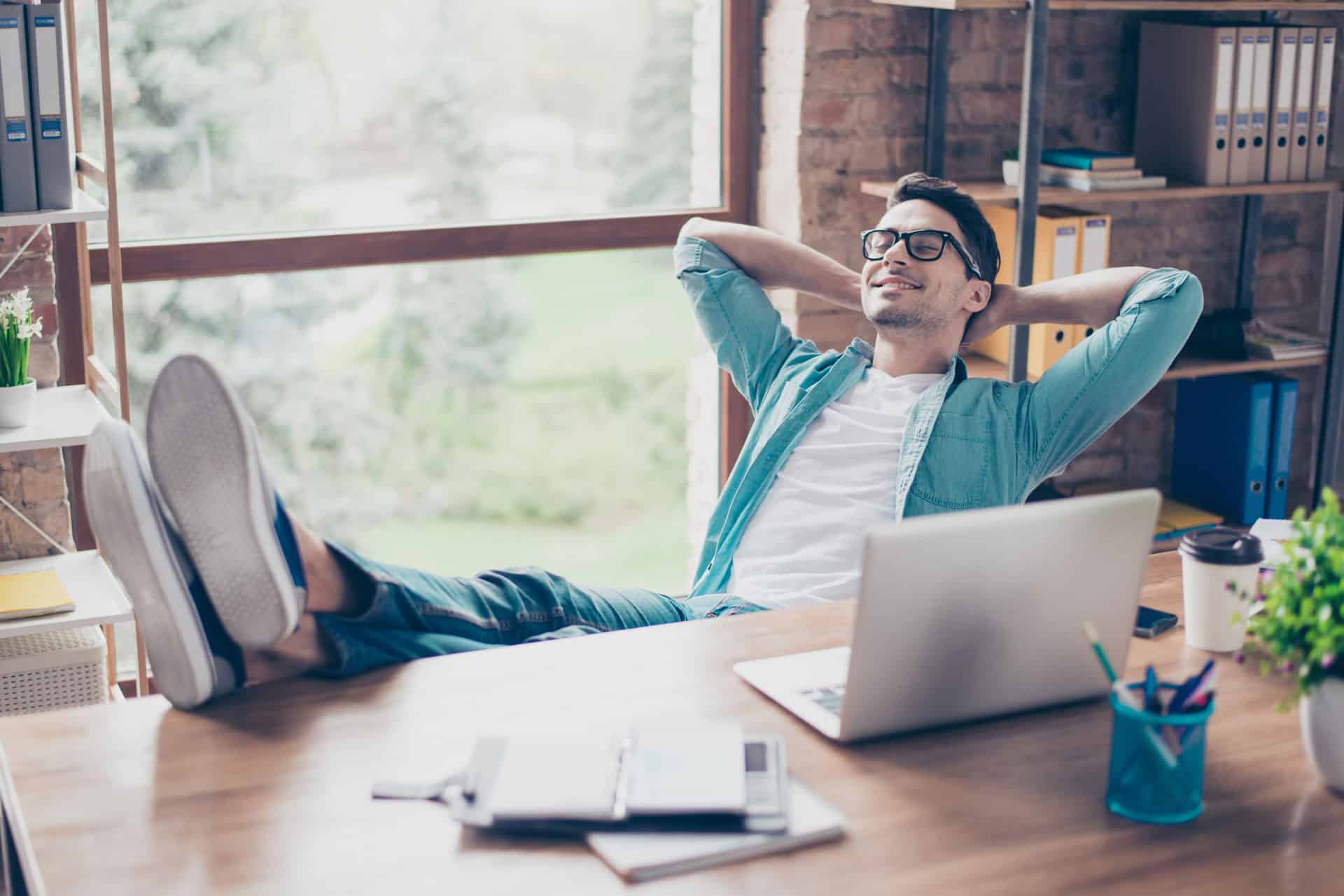 business-owner-relaxing-at-desk business-owner-relaxing-at-desk