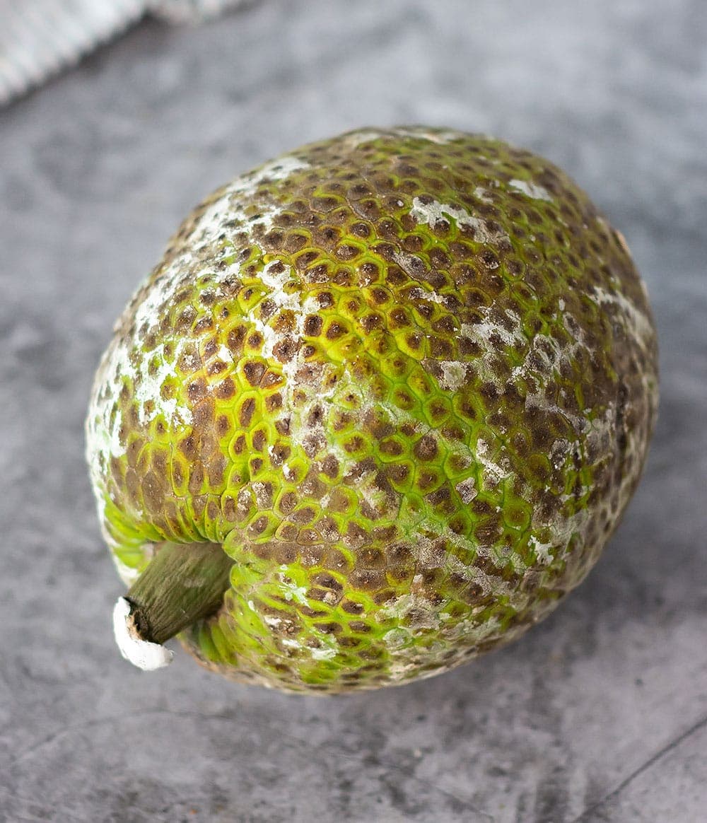 Green Breadfruit for rundown on a marble background