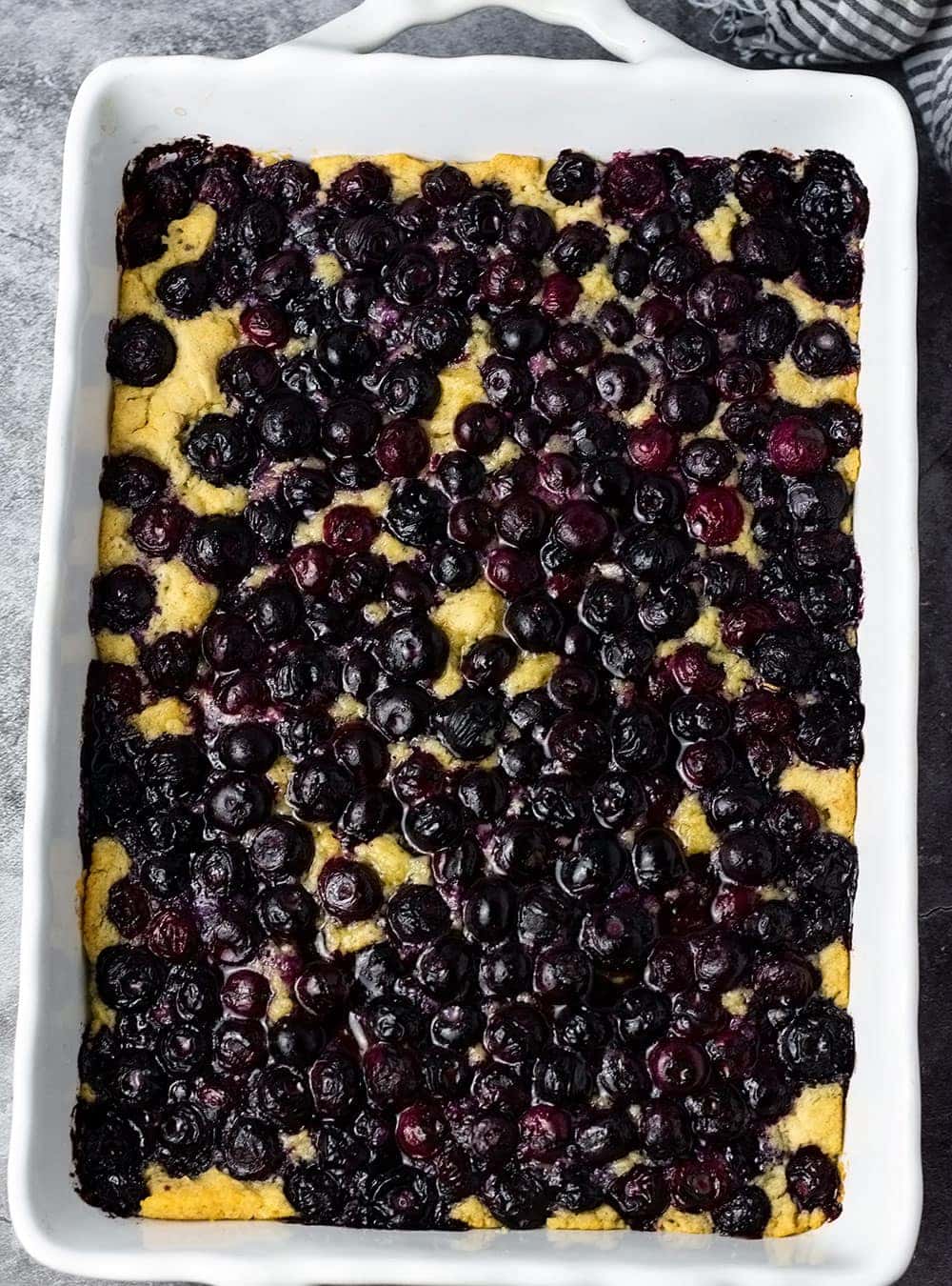Gluten-Free Vegan Blueberry Cake overlay in a white casserole dish