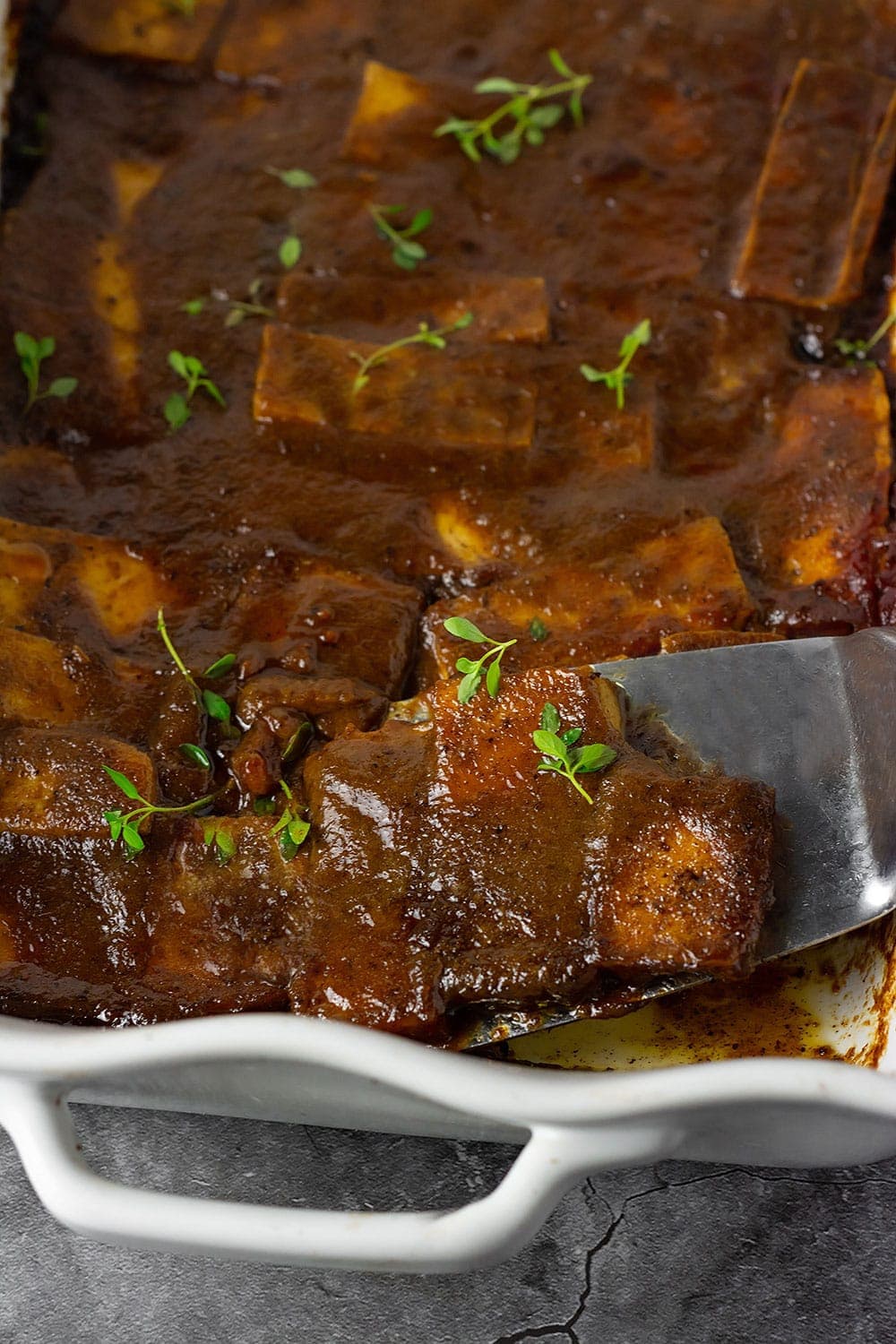 Jerk Tofu Overlay in a white serving pan