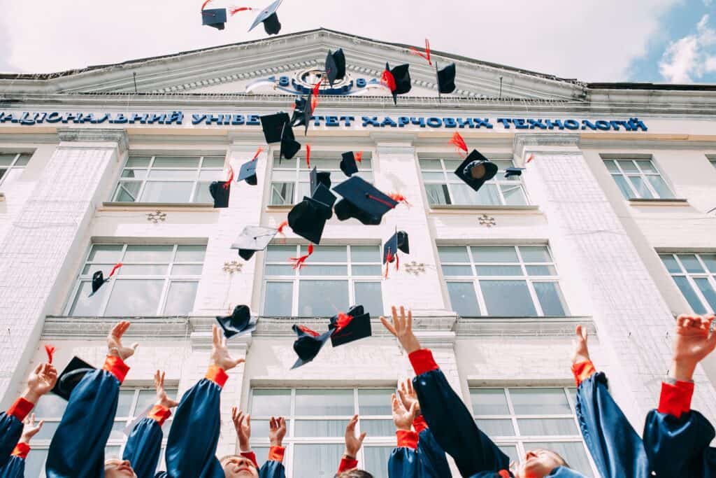 School graduates throwing hats.