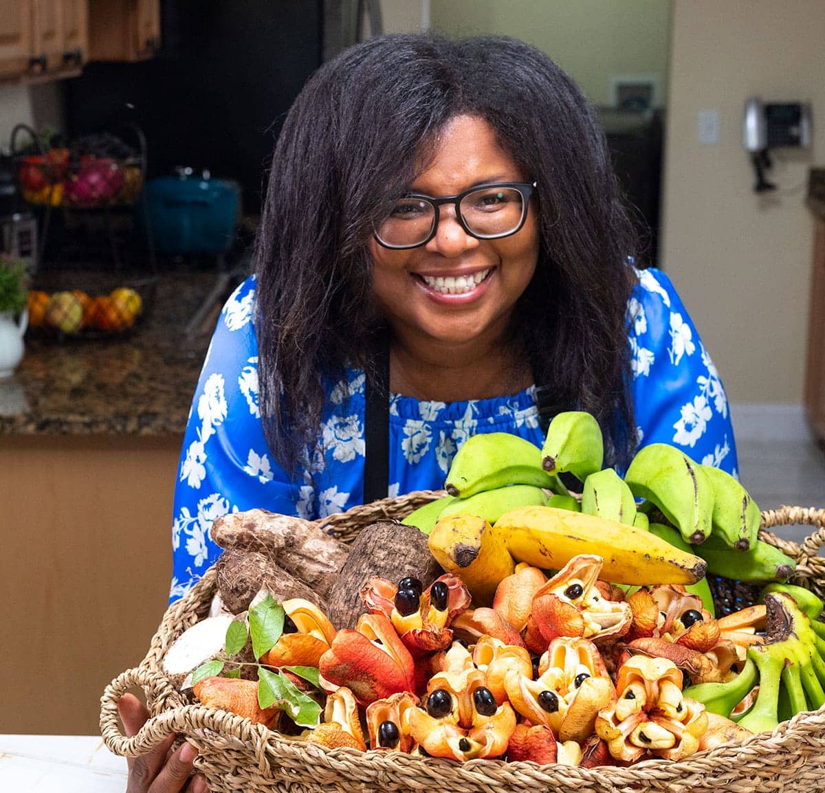 Photo of me holding a basket of jamaican produce including yellow yam