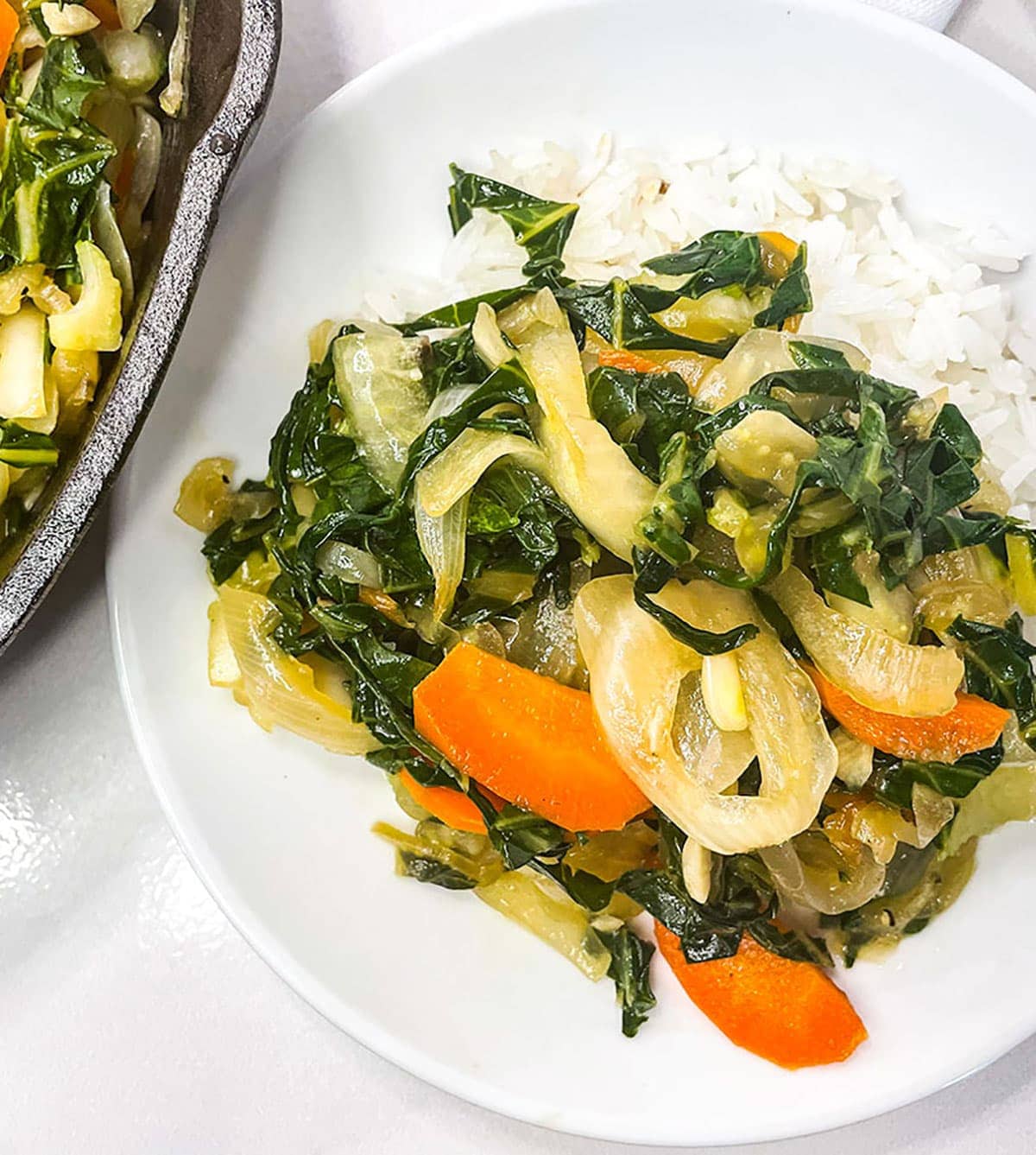 Chop suey served with rice on a white plate