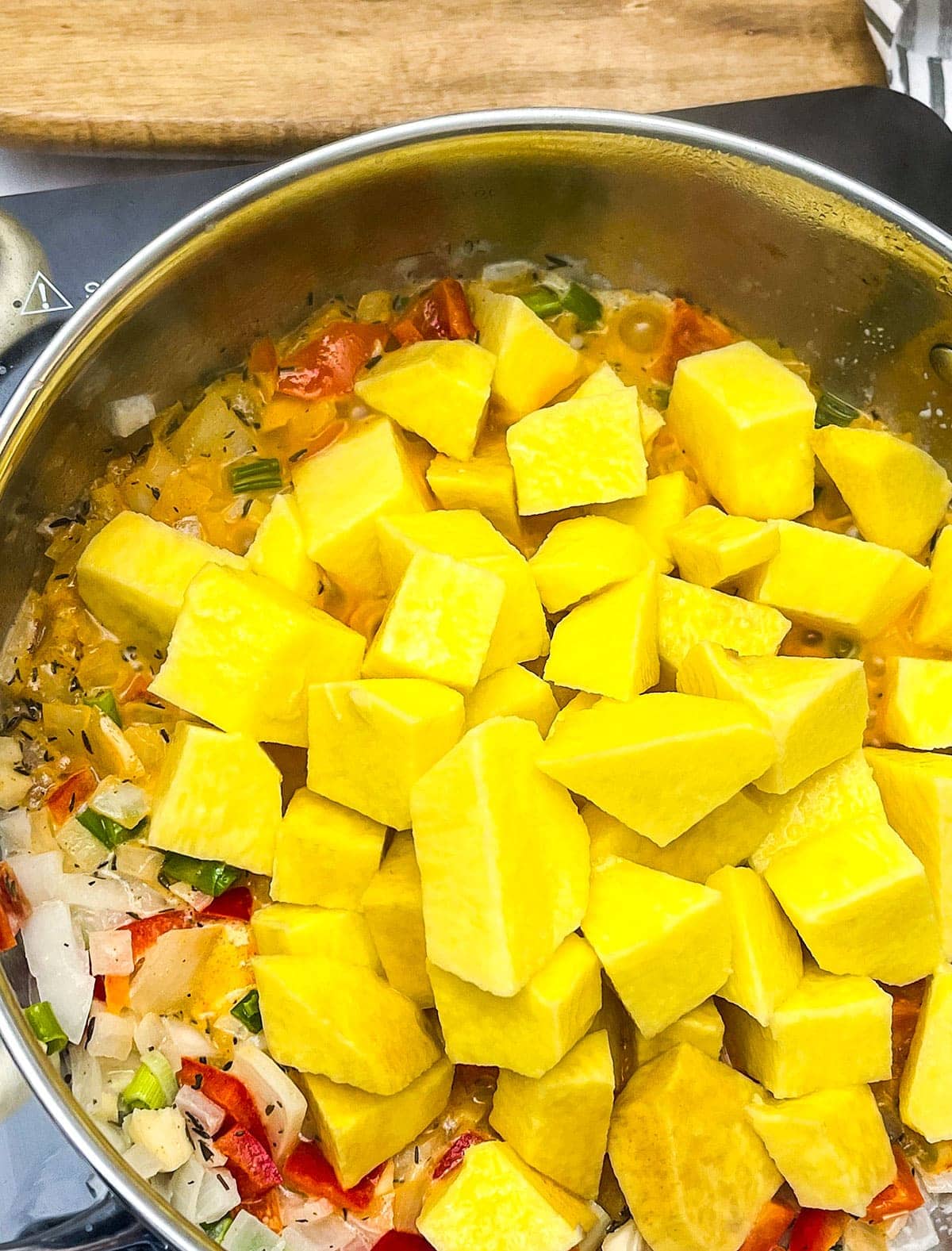 yellow yam and ingredients for yellow yam stew in a saucepan