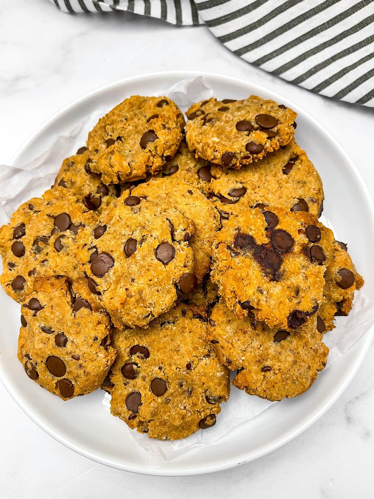 Chocolate chip cookies in a white plate on a white background
