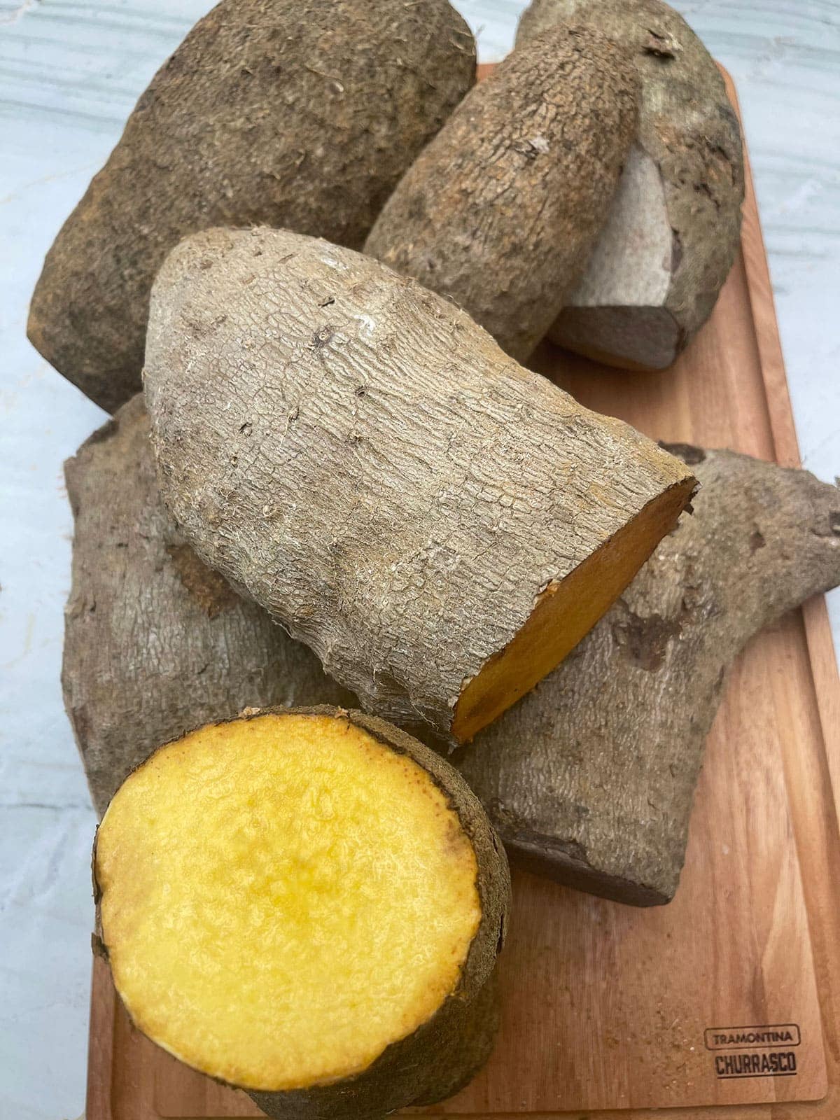 yellow yam tubers on a cutting board