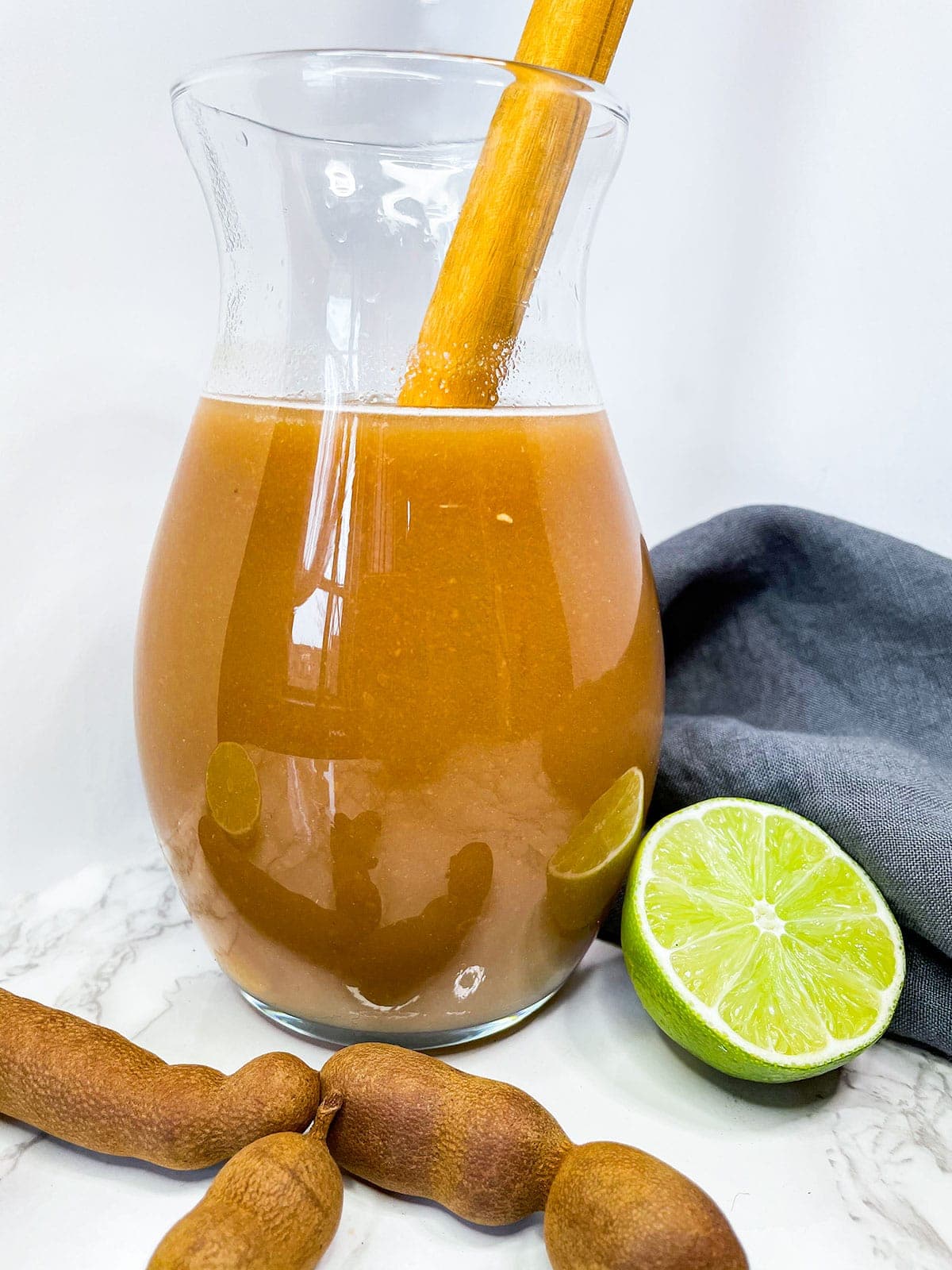 tamarind juice being mixed in a glass jug