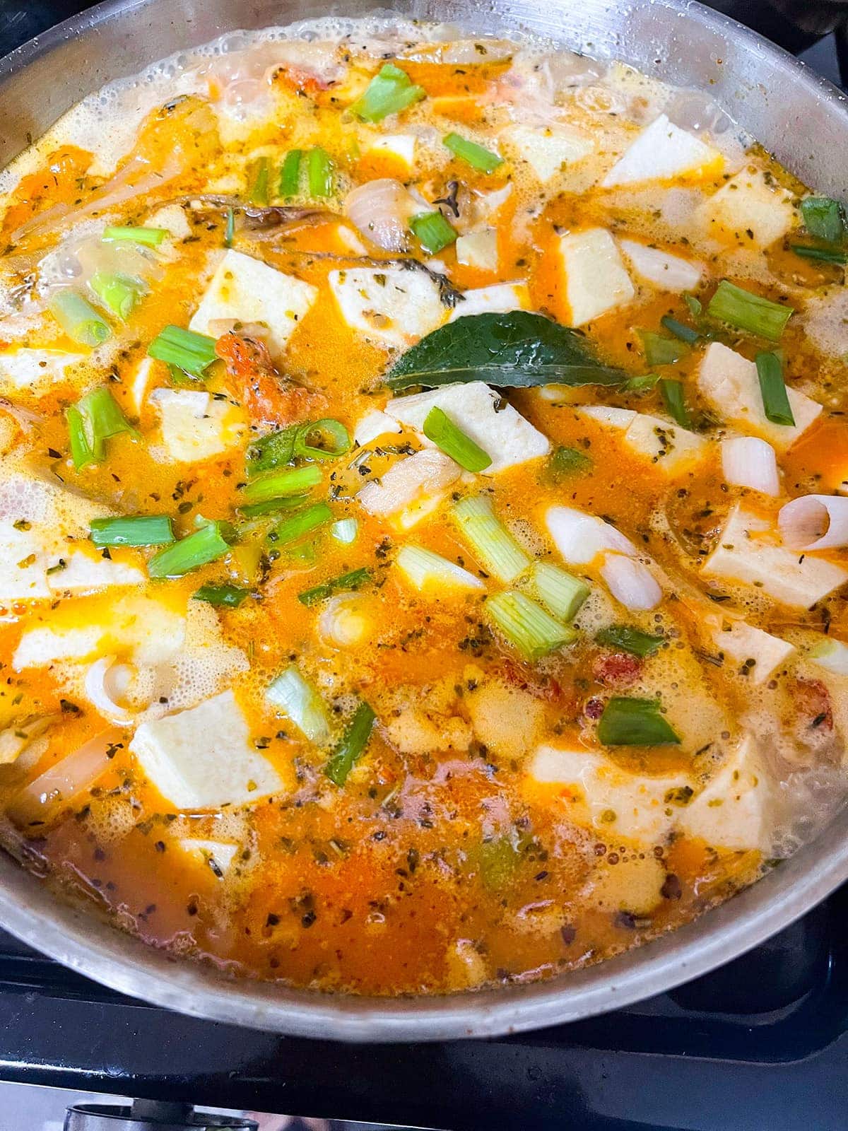 cooking white yam stew in saucepan