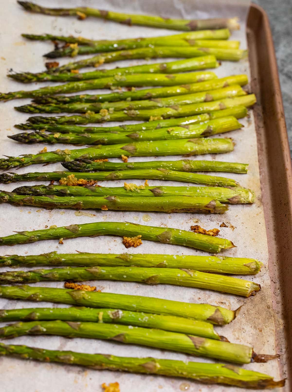 Easy roasted asparagus on a baking sheet lined with parchment paper