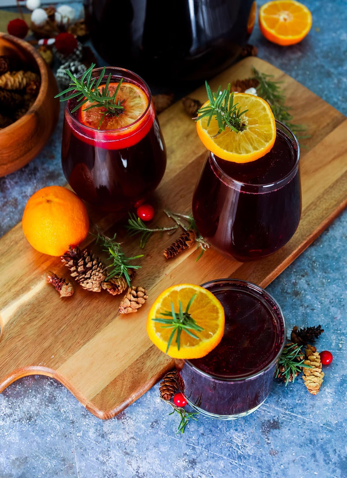 overlay of sorrel drinks in glasses on cutting board on a blue background