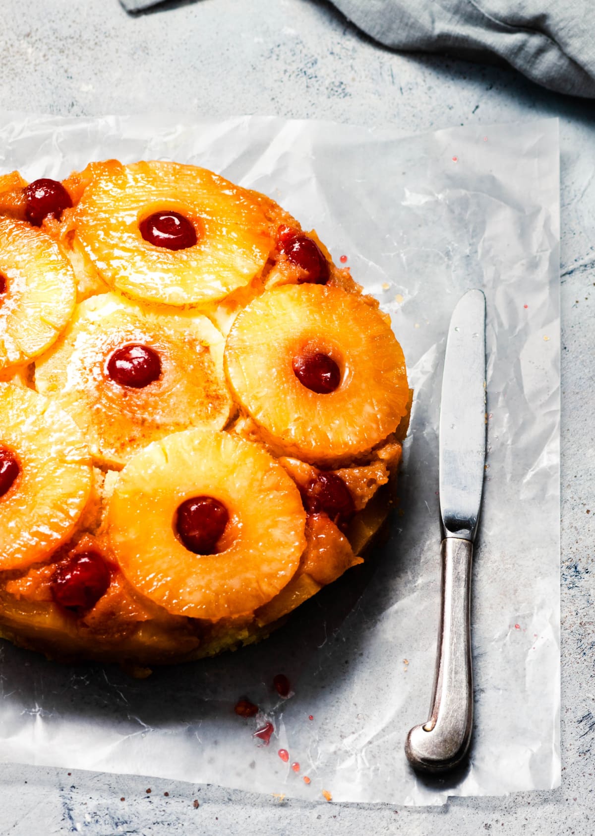 whole pineapple upside down cake on parchment paper