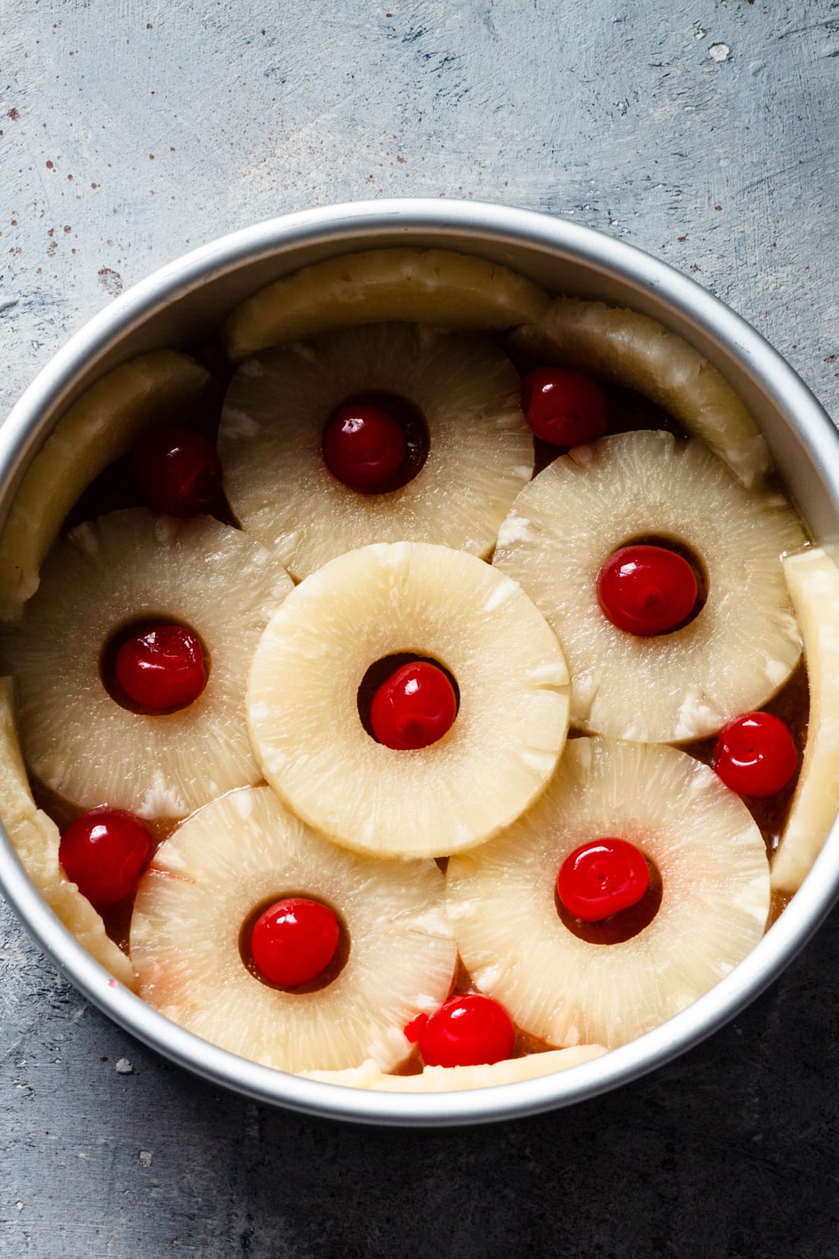 Pineapple upside down cake with pineapple slices and cherries in the middle