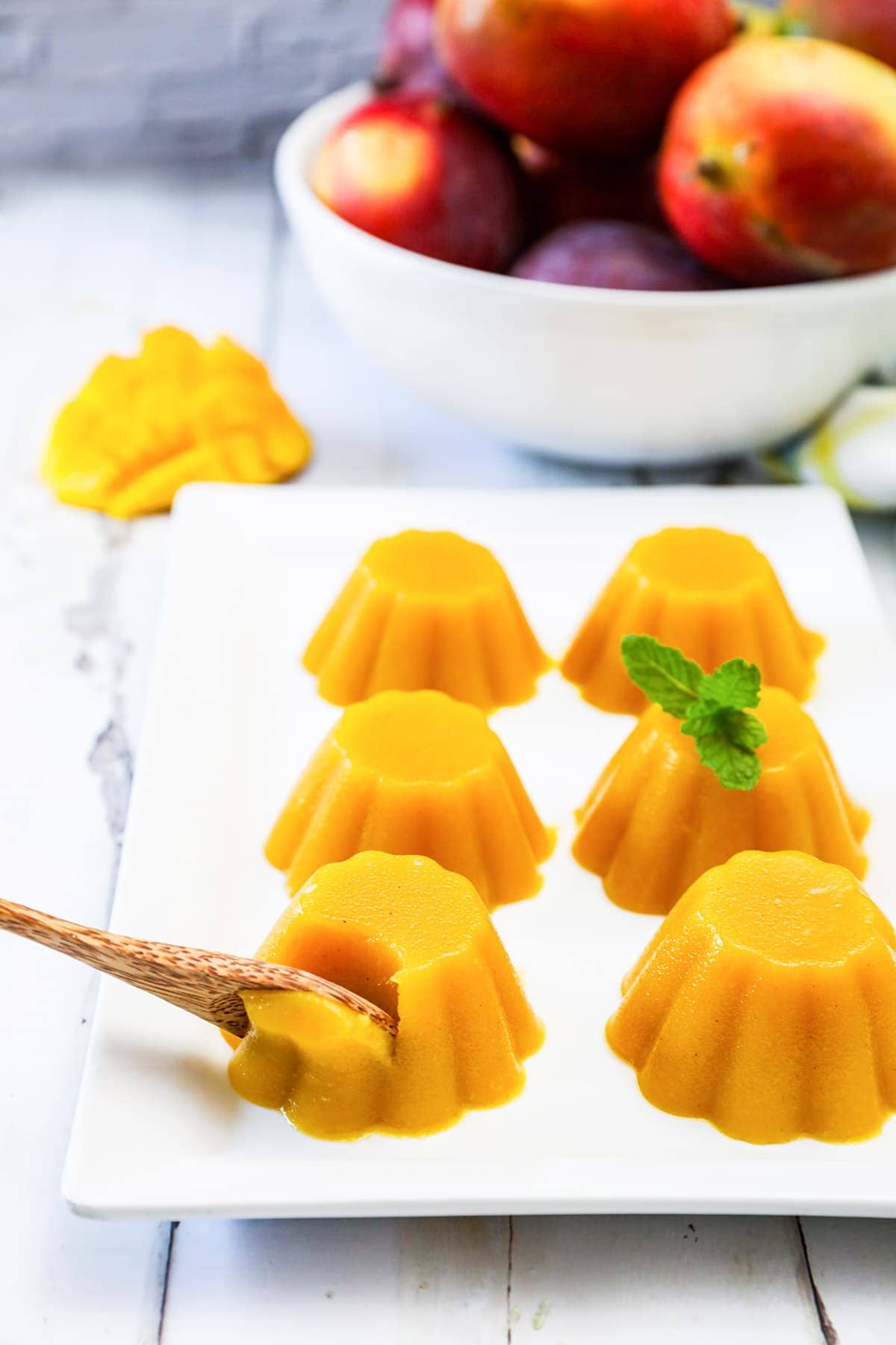 mango pudding on a white platter on wooden background