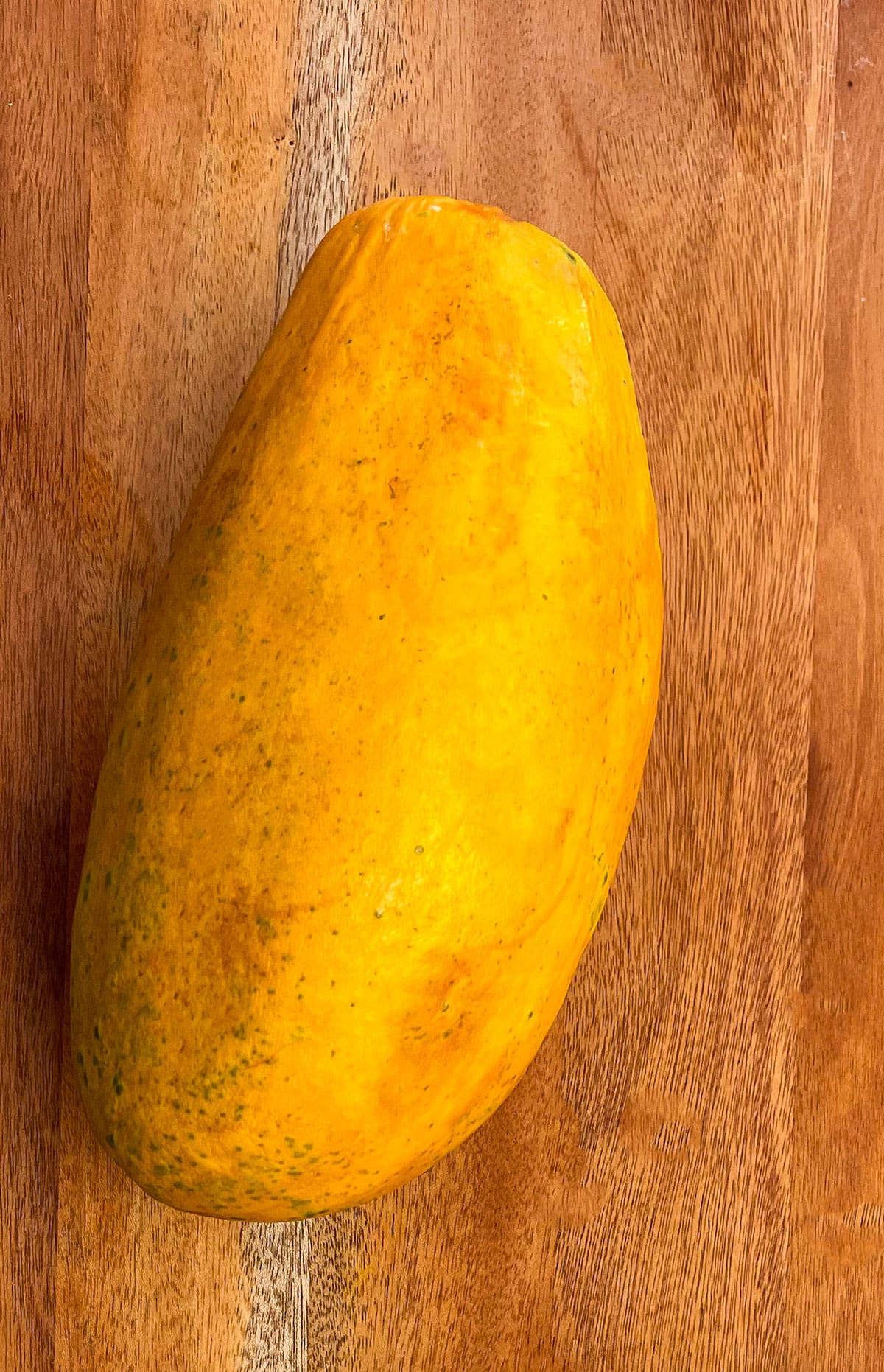whole papaya fruit on a wooden background