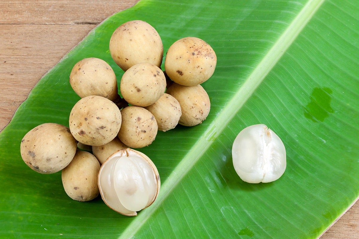 duku fruits on a banana leaf