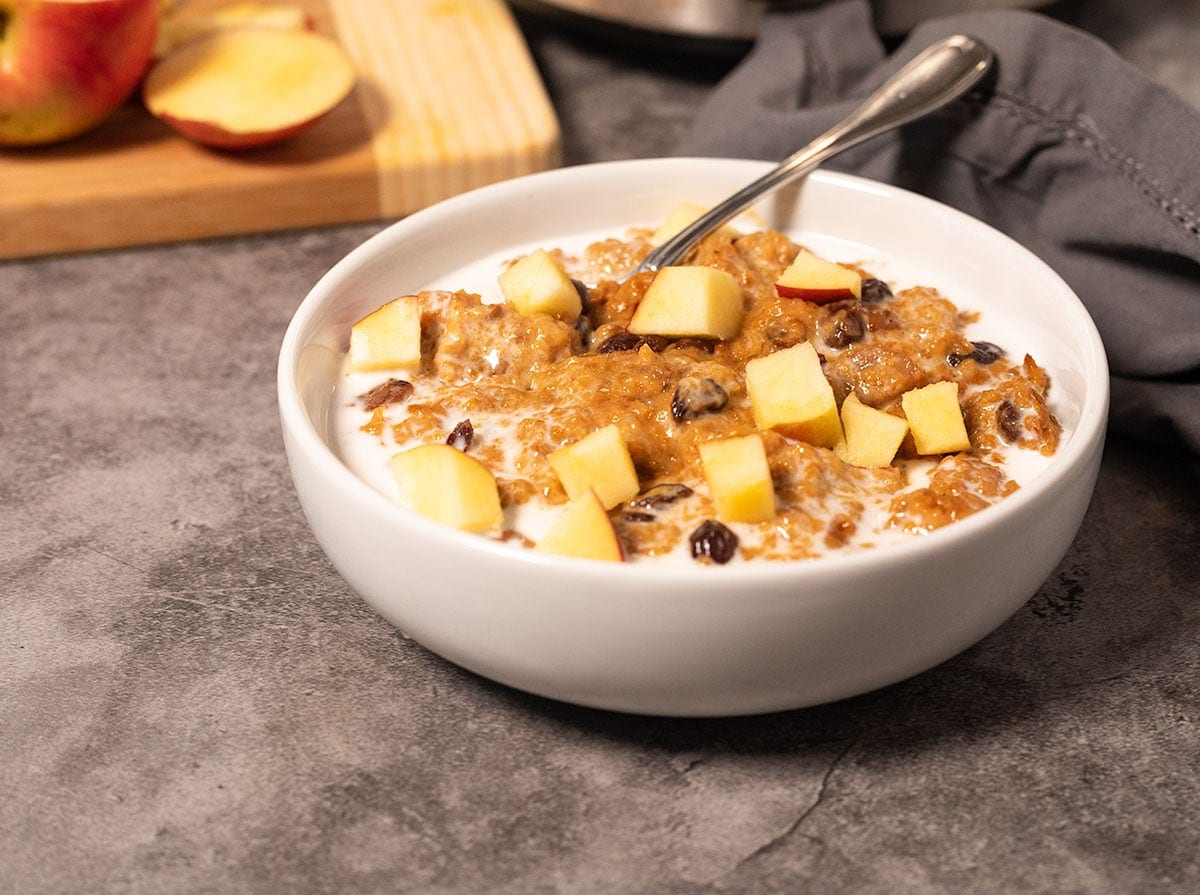 oatmeal made in the crockpot in a white bowl on a grey background