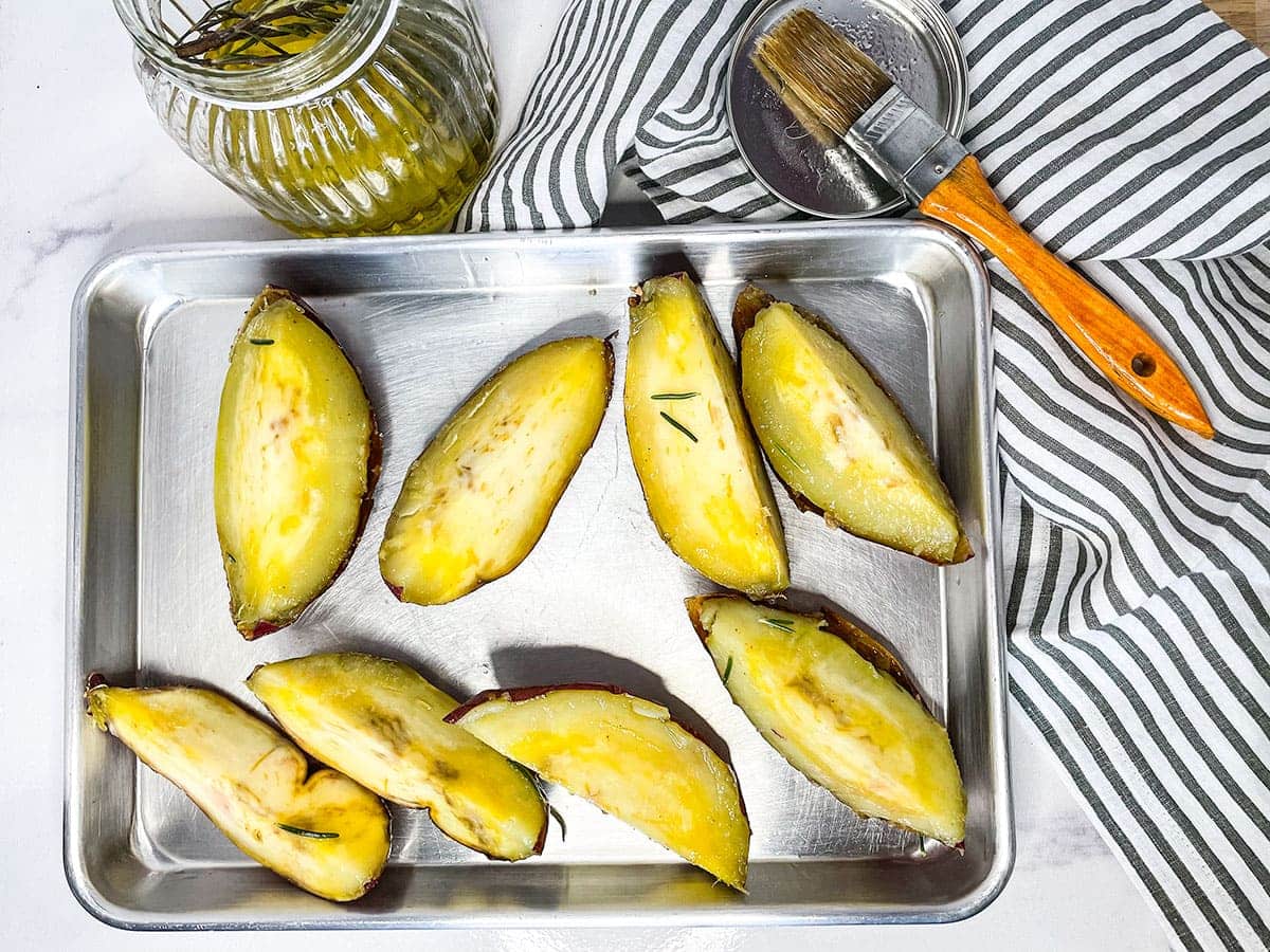 overlay roasted white sweet potatoes on baking sheet