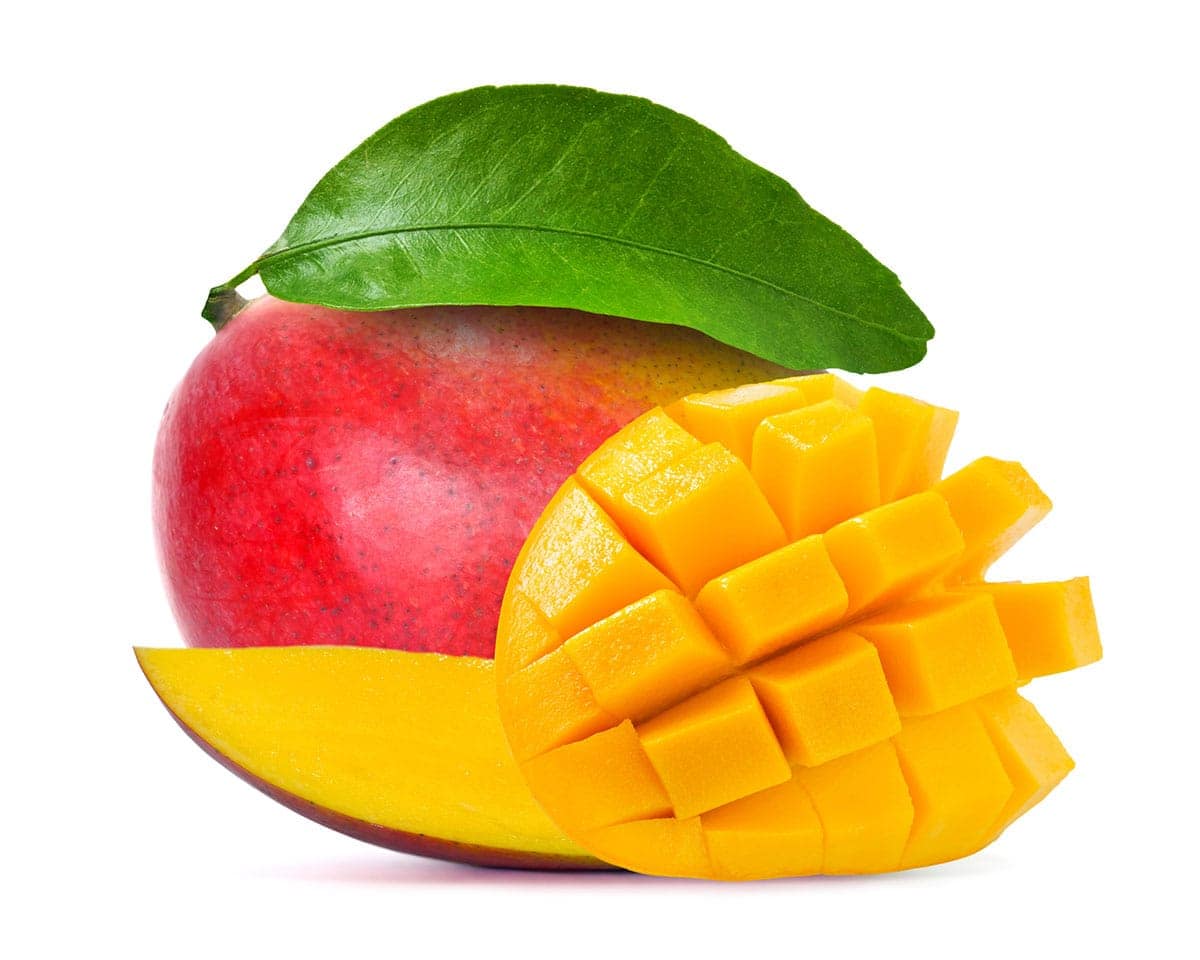 mango cut in cubes, whole and slices on a white background