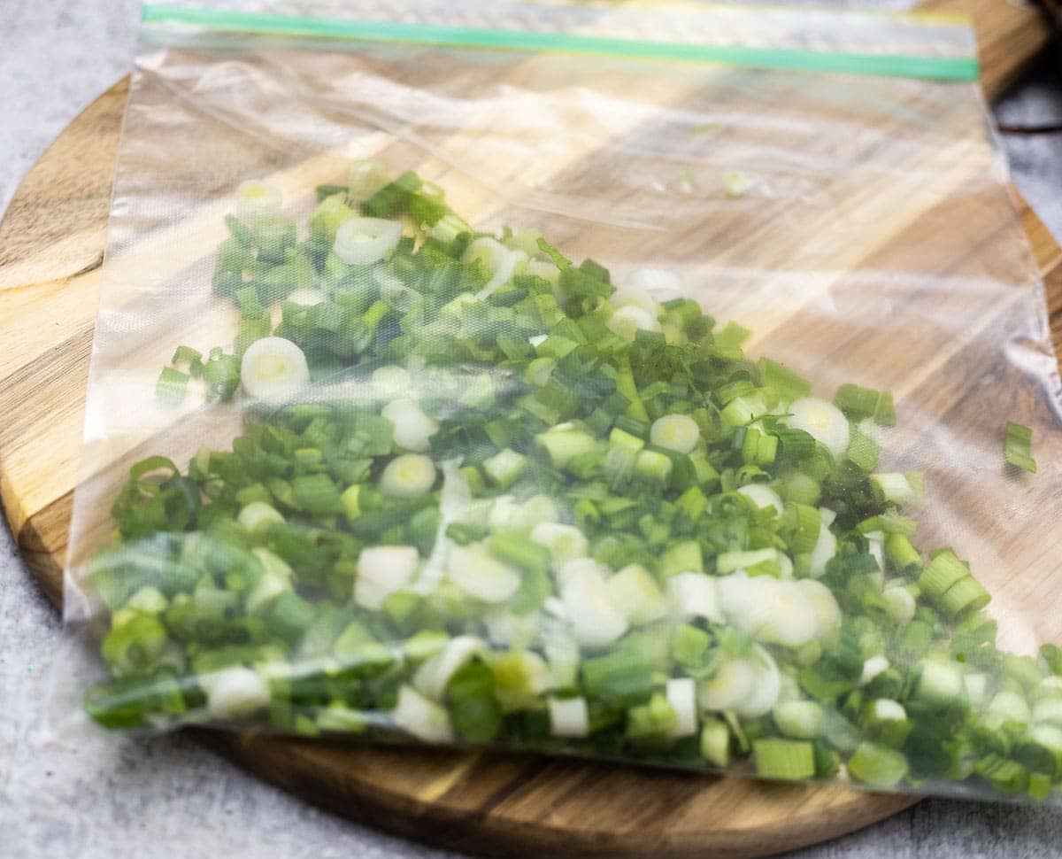 green onion chopped and stored in freezer bag on a cutting board